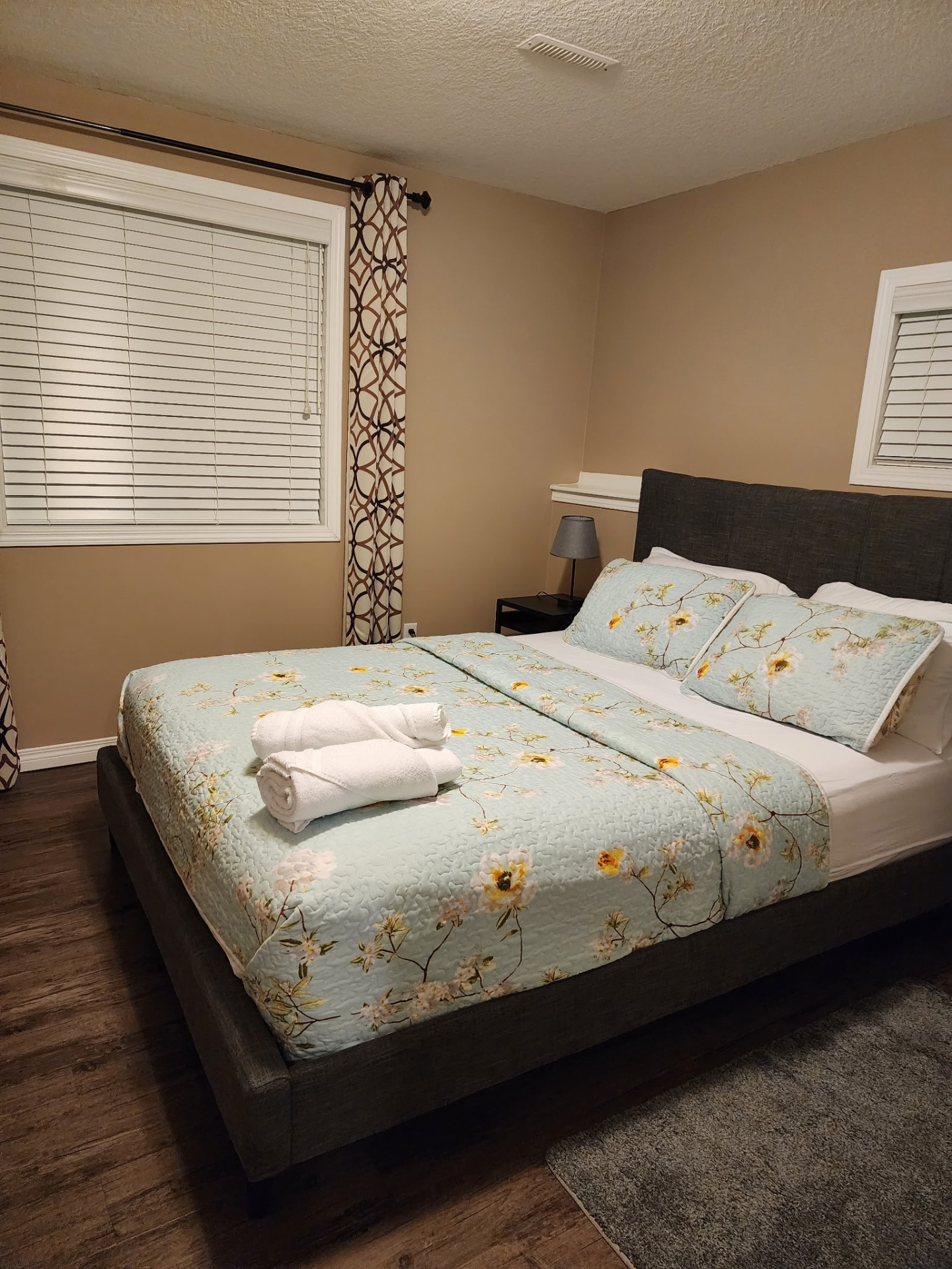 Guest bedroom made up with fresh linens and towels