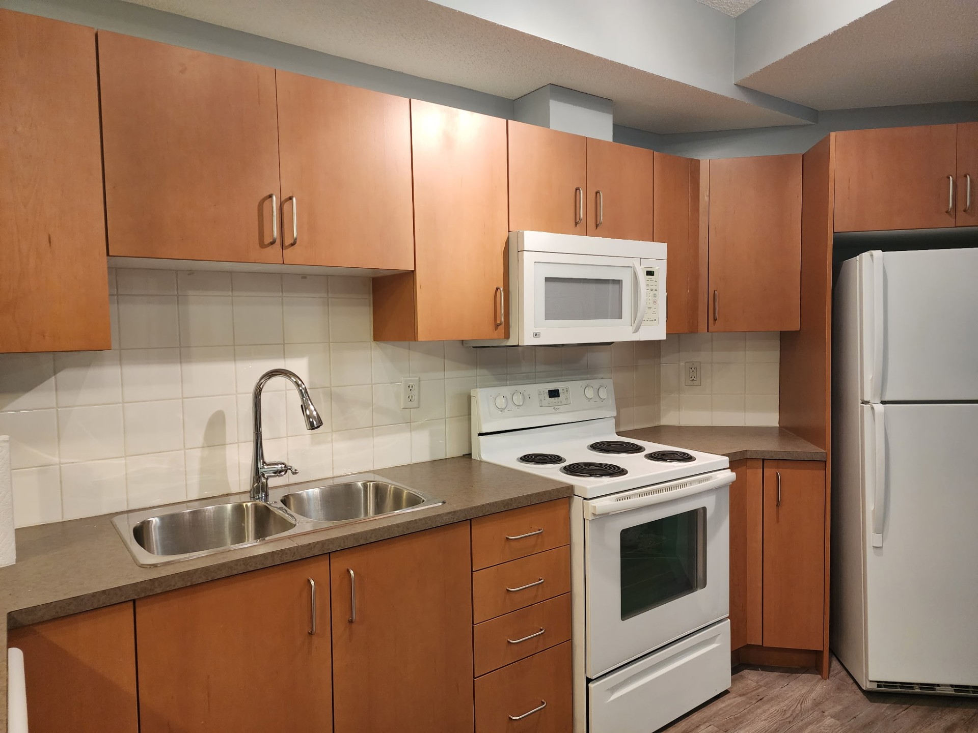 Tidy kitchen with spotless stove and countertops